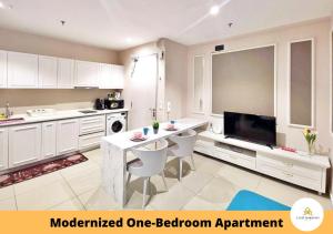 a kitchen with a table and a television in it at I-City I-Soho in Shah Alam