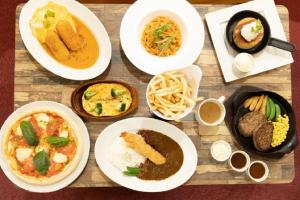 a table with plates of food and bowls of food at プレゼントホテル チャペルガーデン 可児 ｰ大人専用ｰ in Kani +25 photos