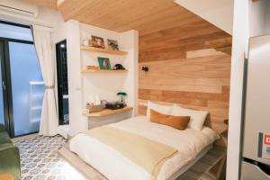 a bedroom with a bed with a wooden wall at South Gate Home Stay in Tainan