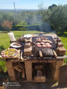 a grill with meat and other food on it at Vignano40 in Siena