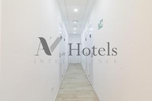 a hallway with a hotel sign on the wall at AYZ Silvela - Auto check-in property in Málaga