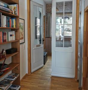 a hallway with a white door and bookshelves at Zur alten Scheune in Balingen