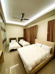 a bedroom with two beds and a ceiling at Villa near SPICE Arena 8BR 45PAX V KTV Pool Table and Kids Swimming Pool in Bayan Lepas