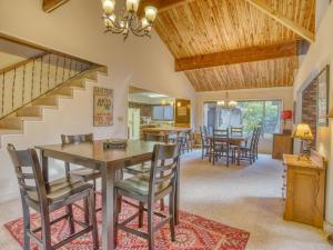a dining room and living room with a table and chairs at Deer View Retreat in Welches