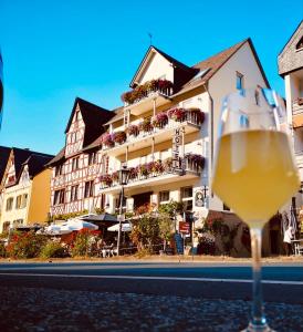 a glass of wine in front of a building at Hotel St. Georg in Ediger-Eller