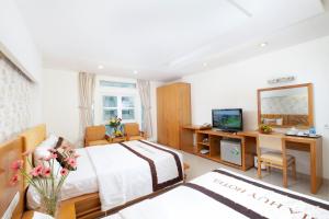 Postel nebo postele na pokoji v ubytování Gia Huy Hotel