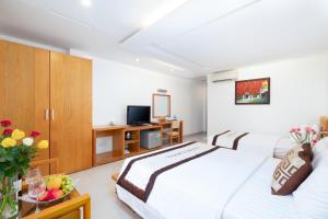 Postel nebo postele na pokoji v ubytování Gia Huy Hotel
