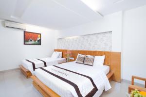 Postel nebo postele na pokoji v ubytování Gia Huy Hotel