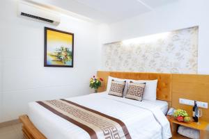 Postel nebo postele na pokoji v ubytování Gia Huy Hotel