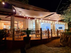 a restaurant with lights on a deck at night at Eco Hotel Montemerlo in Fetovaia