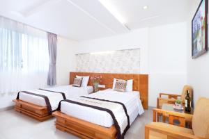 Postel nebo postele na pokoji v ubytování Gia Huy Hotel + 26 fotografií
