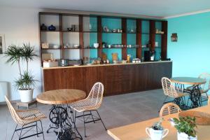 a restaurant with tables and chairs in a room at Villa da Bica in Lourinhã