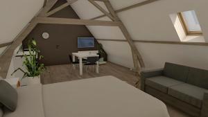 a attic room with a bed and a table and a desk at Hoeve Ten Rooden Duifhuize in Sint-Denijs