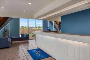 an empty lobby with a bar with a view at Baymont by Wyndham Daytona Beach - Intl Speedway in Daytona Beach