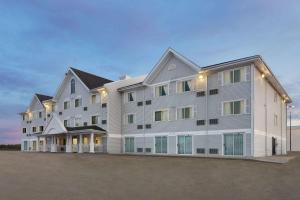 a large apartment building with lights on it at Ramada by Wyndham Miramichi New Brunswick in Miramichi