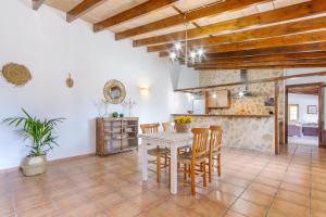 a kitchen and dining room with a table and chairs at Marilen - Finca with Large Garden & Pool in Alcudia