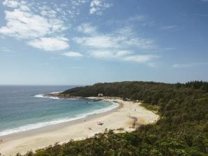 a view of a beach with people on it at Kioloa Beach Cabins in Kioloa