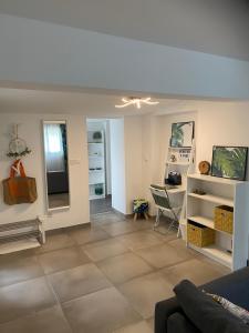 a living room with a couch and a table at le Garden Cocoon in Istres