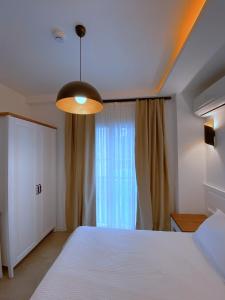 A bed or beds in a room at Amber Boutique Hotel