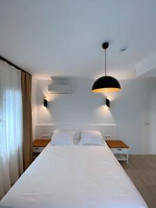 A bed or beds in a room at Amber Boutique Hotel