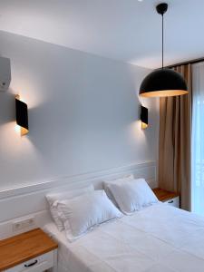 A bed or beds in a room at Amber Boutique Hotel