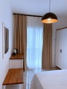 A bed or beds in a room at Amber Boutique Hotel