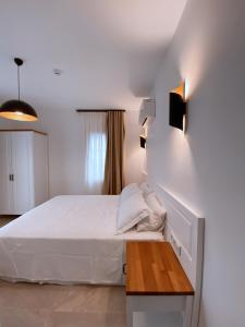 A bed or beds in a room at Amber Boutique Hotel