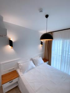 A bed or beds in a room at Amber Boutique Hotel