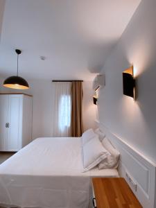 A bed or beds in a room at Amber Boutique Hotel