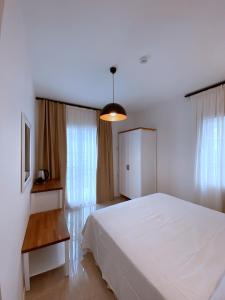 A bed or beds in a room at Amber Boutique Hotel