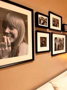 a wall with pictures of a woman talking on a cell phone at DeGasperi Studio Apartment in Trani