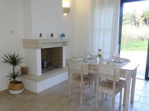 a dining room with a table and a fireplace at Villa Anna Maria Otranto in Otranto