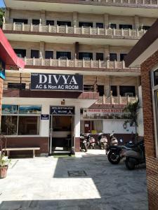 a building with motorcycles parked in front of it at HOTEL DIVYA in Rishīkesh