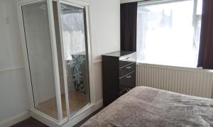 a bedroom with a glass shower and a bed at 7 Bats in Lincolnshire