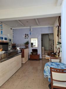a large kitchen with blue walls and a table at Hotel Marconi Miramare in Rimini