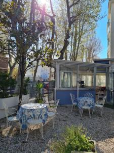 a patio with a table and chairs and a gazebo at Hotel Marconi Miramare in Rimini