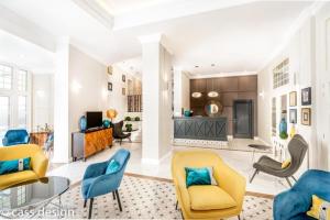 a living room with yellow and blue chairs at Artemis in Băile Herculane