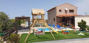 a playground with a slide and a swing set at Stergios villa in Kolymbia
