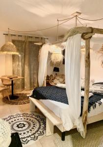 a bedroom with a wooden bed with a canopy at La Villa Tosca in Callas