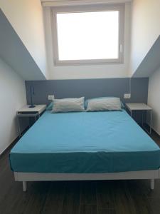 En eller flere senge i et værelse på Appartamento in Villa con idromassaggio