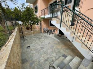 a patio with stairs and a table and chairs at Nala's apartment I in Nafplio