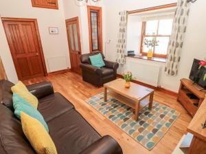 a living room with a couch and a coffee table at Cygnet Cottage in Berwick-Upon-Tweed