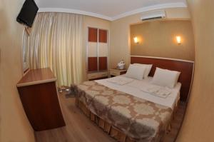 Postel nebo postele na pokoji v ubytování Epic Hotel
