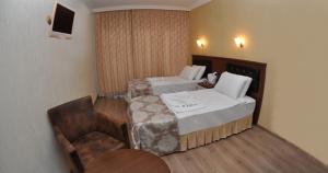 Postel nebo postele na pokoji v ubytování Epic Hotel
