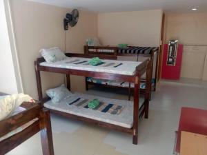 a room with three bunk beds in it at BM Island Inn in Bantayan Island