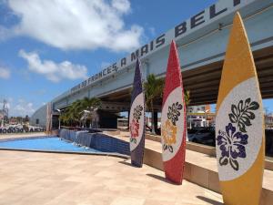 a group of surfboards standing in front of a swimming pool at Meu Cantinho na Praia do Frances in Marechal Deodoro