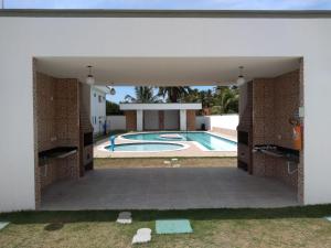 a view of a swimming pool from the outside of a house at Meu Cantinho na Praia do Frances in Marechal Deodoro
