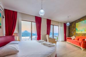 a bedroom with a large bed and a red couch at Selimiye Lime Garden in Selimiye +58 photos