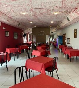 un comedor con mesas y sillas rojas en A lastra, en Villamartín