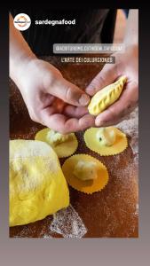 a person holding a piece of food on a counter at Agriturismo Guthiddai in Oliena